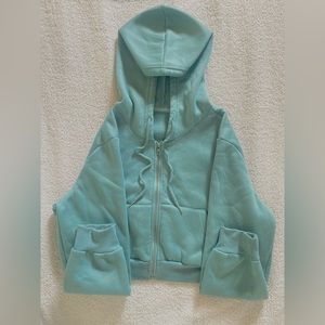 This is a one time worn green/blue zip up in very good condition.